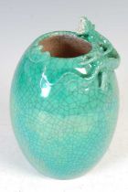 A Chinese porcelain monochrome crackle glaze vase, Qing Dynasty, decorated in relief with a