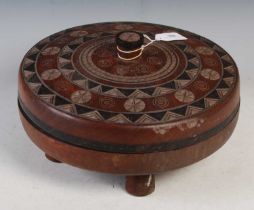 Tribal Art - An African carved wood circular storage box and cover, the detachable cover with