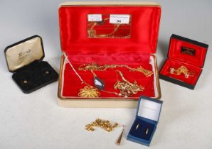 Costume jewellery box containing assorted yellow metal costume jewellery, brooches, pendants, tie