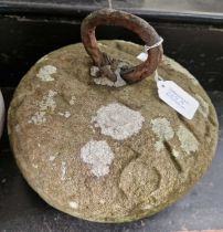 An antique tethering stone/ curling stone.