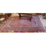 Large red patterned wool rug - Approx size: 290cm x 188cm