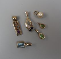 6 assorted 9ct gold stone set pendants - Approx gross weight 6g