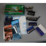 Collection of harmonicas and pennywhistles etc