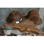 2 military helmets together with military cap