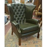 Green wing-back armchair