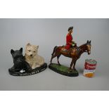Figurine of the Queen riding a horse together with a Black and White Whisky figurine