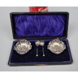 Hallmarked silver shell shaped salts and spoons in original box