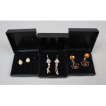 Collection of moonstone, opal and amber earrings on silver