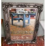 Ornate framed bevelled glass mirror