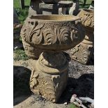 Pair of stone planters on plinths