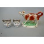 2 Victorian cat head money boxes and Staffordshire cow creamer