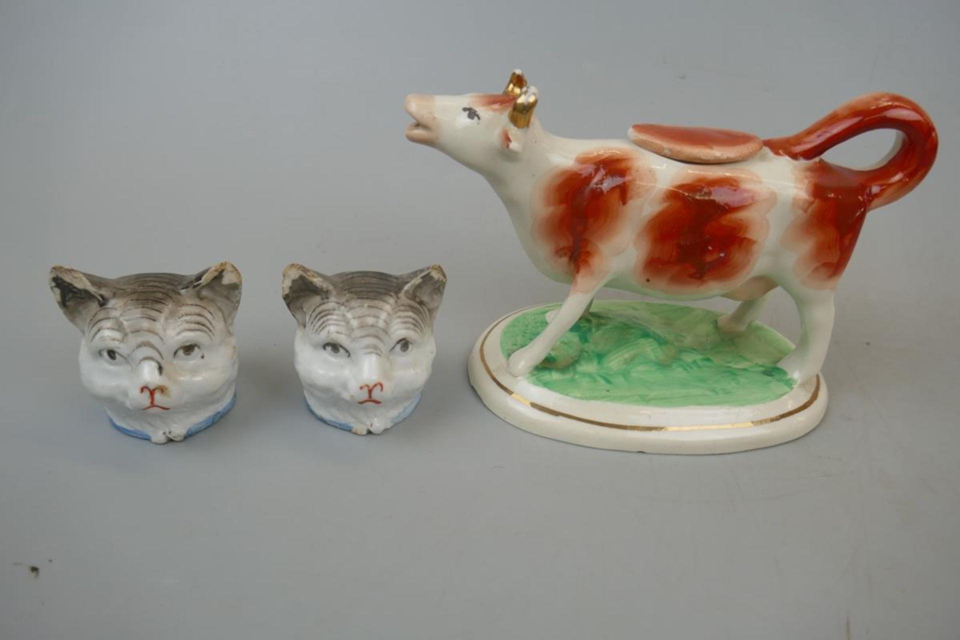 2 Victorian cat head money boxes and Staffordshire cow creamer