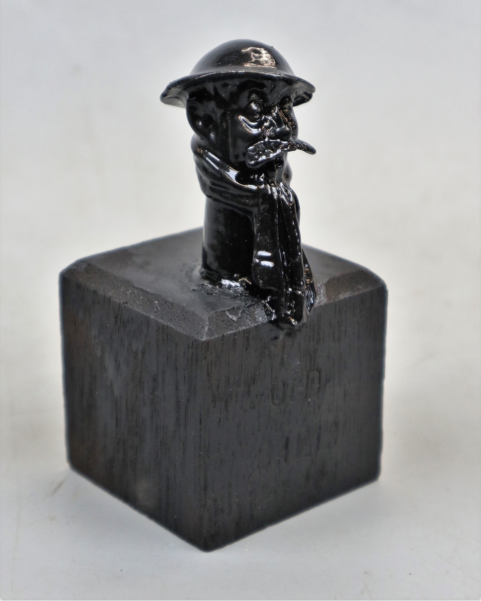 Old Bill black painted mascot on wooden base