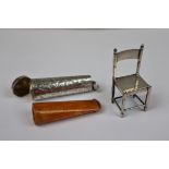 2 pieces of hallmarked silver. The first an Amber cheroot holder within its silver case. The other a