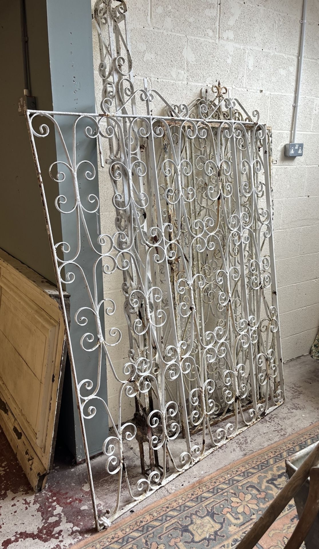 3 scroll metal gates together with a large scroll metal fence and post