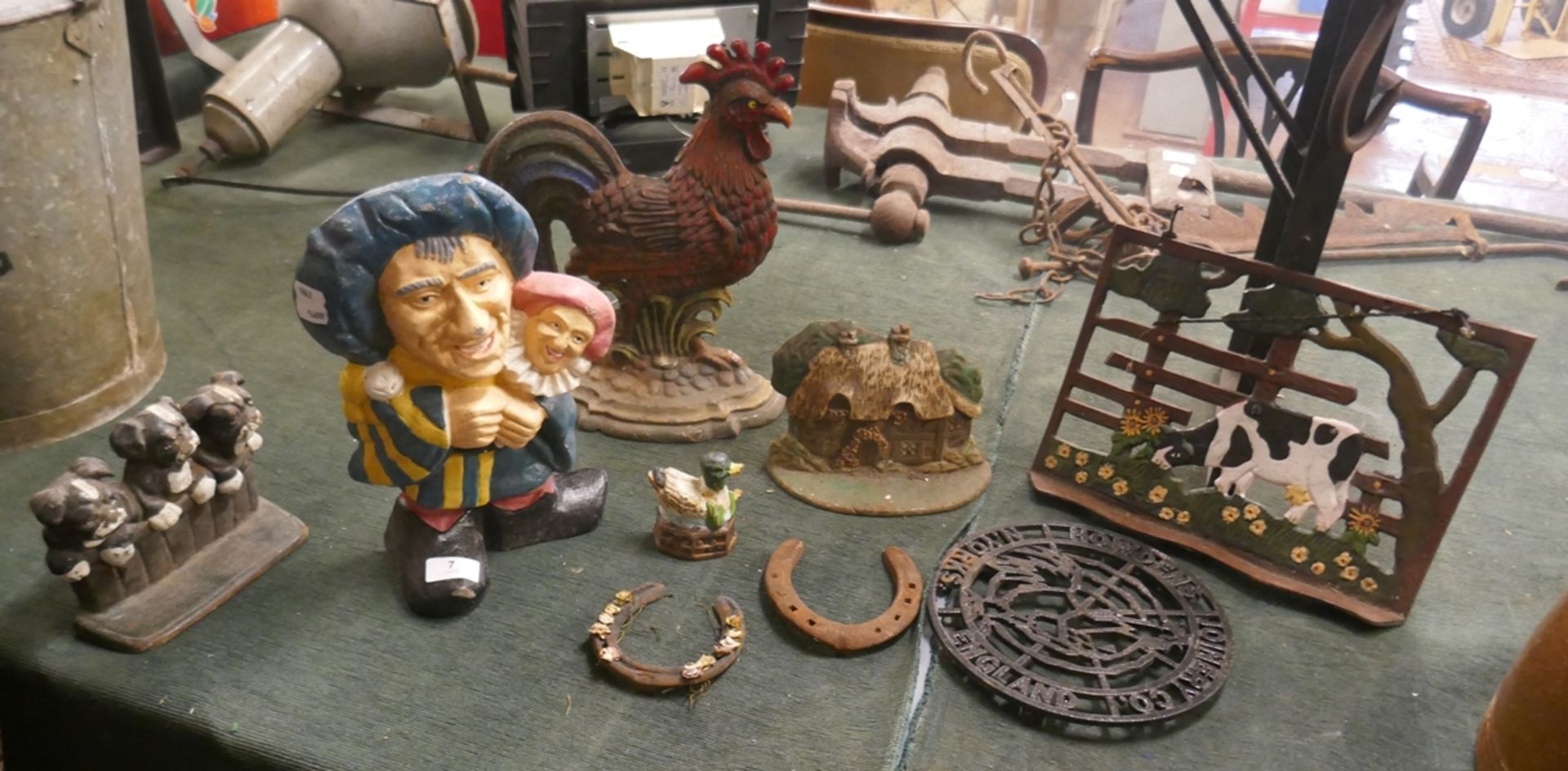 Collection of cast iron items to include door stops etc