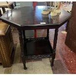 Octagonal 2 tier mahogany table on castors