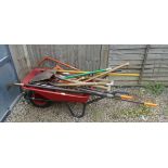 Large collection of gardening tools together with a wheelbarrow