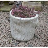 Stone log planter with plants