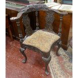 Fine carved oak corner chair adorned with flowers