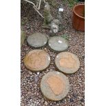 5 round stepping stones each with a motif