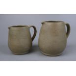 2 graduated pottery jugs