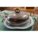 Large ceramic serving platter together with a silver plate handled cloche