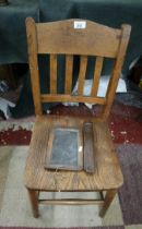 Antique school chair together with writing slate and boxed crayons