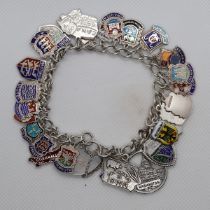 A silver charm bracelet with crest charms - Approx weight 52g