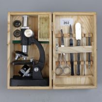 Junior microscope in wooden case with slides etc