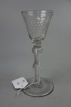 Georgian wine glass with round funnel bowl on double knopped air twist stem with conical foot