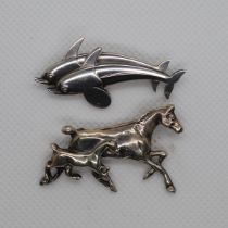 Silver horse and silver dolphin brooches