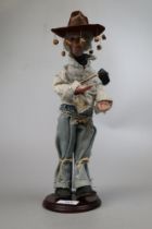 Musical figurine of an Australian swagman. Plays Waltzing Matilda