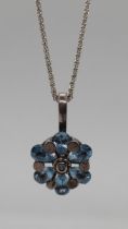 Silver and blue topaz pendant on silver chain