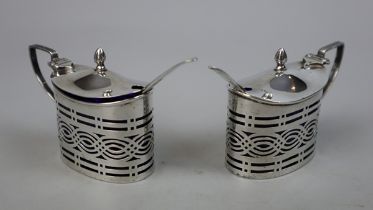 Pair of hallmarked silver salts with pierced body and cobalt blue glass liners