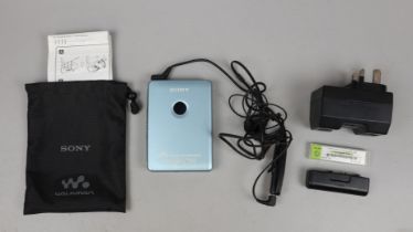 Sony Walkman cassette player model no. WM-EX615/EX610 with battery, battery extender, charger,