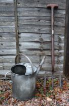 Galvanised watering can together with vintage potato fork