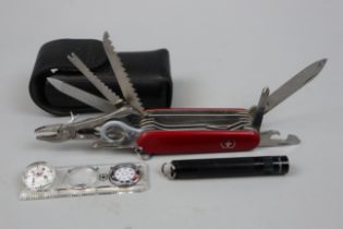 Swiss army knife in pouch with accessories to include compass magnifying glass and torch etc