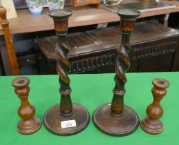 Pair of oak barley twist candle sticks together with another