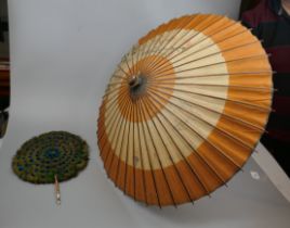 Peacock feather fan together with parasol
