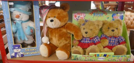 Pair of singing bears in original packaging together with a skiing snowman in original box and a