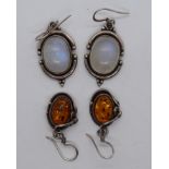 2 pairs of earrings one set with amber the other moonstone