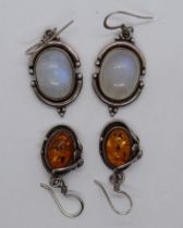 2 pairs of earrings one set with amber the other moonstone