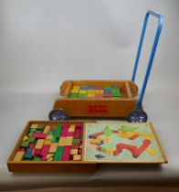 A vintage Childs push trolley with building blocks together with extra set of building blocks