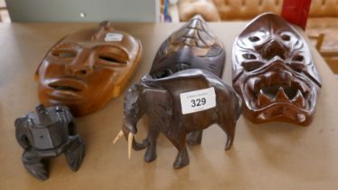 3 tribal masks together with 2 carved animals