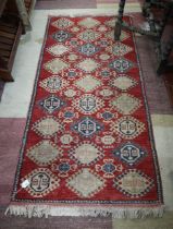 Red patterned rug - Approx size: 92cm x 192cm