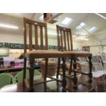 A pair of mid-20th century oak high back dining chairs with drop in seats