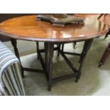 An early 20th century mahogany/oak inlaid drop leaf table