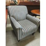 A modern chair upholstered in a cut striped fabric