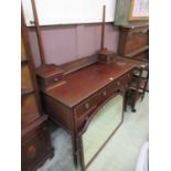 An early 20th century mahogany dressing table with mirror and trinket drawers to back, the base